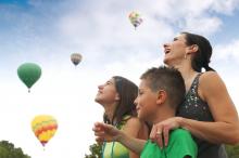 family watching hot air ballons